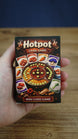Compact Palia-inspired Hotpot card game box held in hand to show the portable size, detailed artwork, and mini card game packaging.