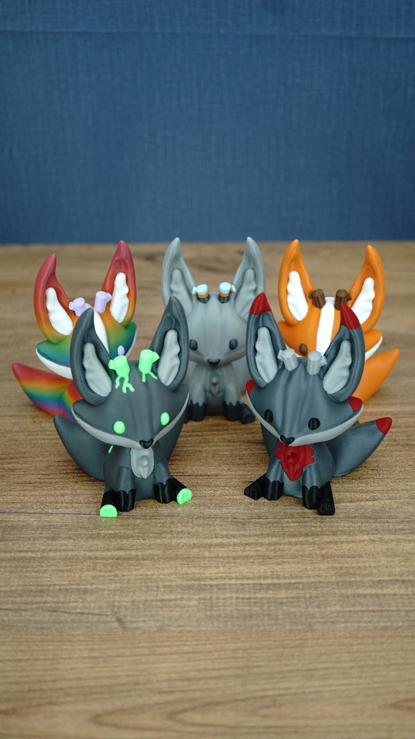 Five Palia Kitsuu 3D printed figures in different variants displayed together on a wooden tabletop.