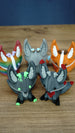 Close-up of five Palia Kitsuu figures, including Cave Kitsuu and other colourful variants, arranged on a wooden tabletop.