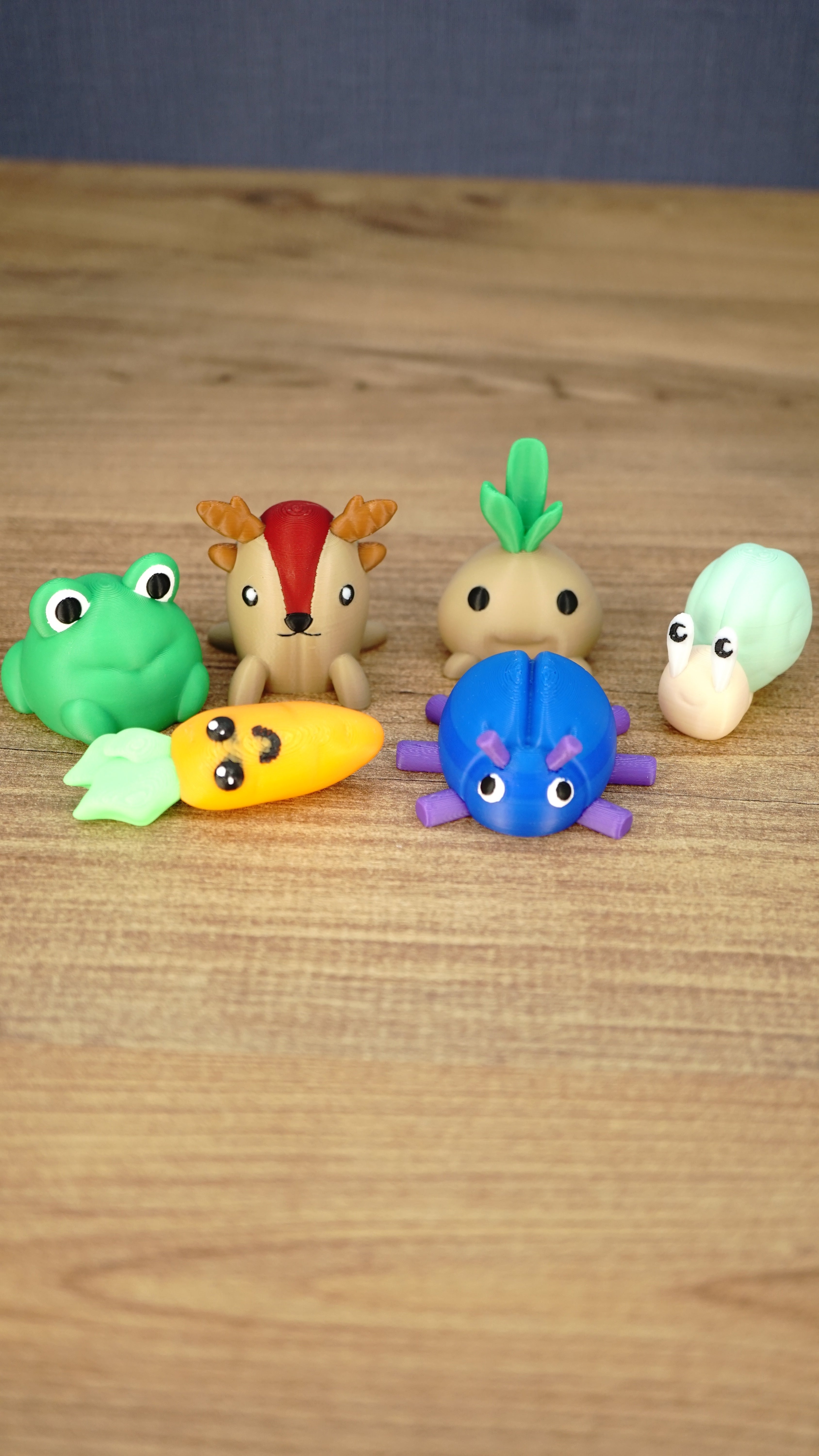 Complete Palia Zeki’s Claw Machine Li’l Plushies bundle with beetle, carrot, frog, sernuk, turnip and snail miniatures on a wooden table.