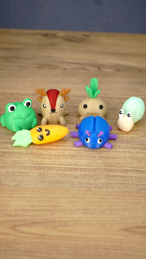 Complete Palia Zeki’s Claw Machine Li’l Plushies bundle with beetle, carrot, frog, sernuk, turnip and snail miniatures on a wooden table.