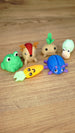 Angled view of six Palia-inspired Li’l Plushies miniatures featuring Li’l Froggy, Sernuk, Turnip, Snail, Carrot and Beetle.