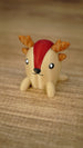 Close-up of the Li’l Sernuk collectible miniature with a tan body, red forehead stripe, brown antlers and a sweet painted face.