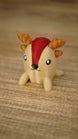 Close-up of the Li’l Sernuk collectible miniature with a tan body, red forehead stripe, brown antlers and a sweet painted face.