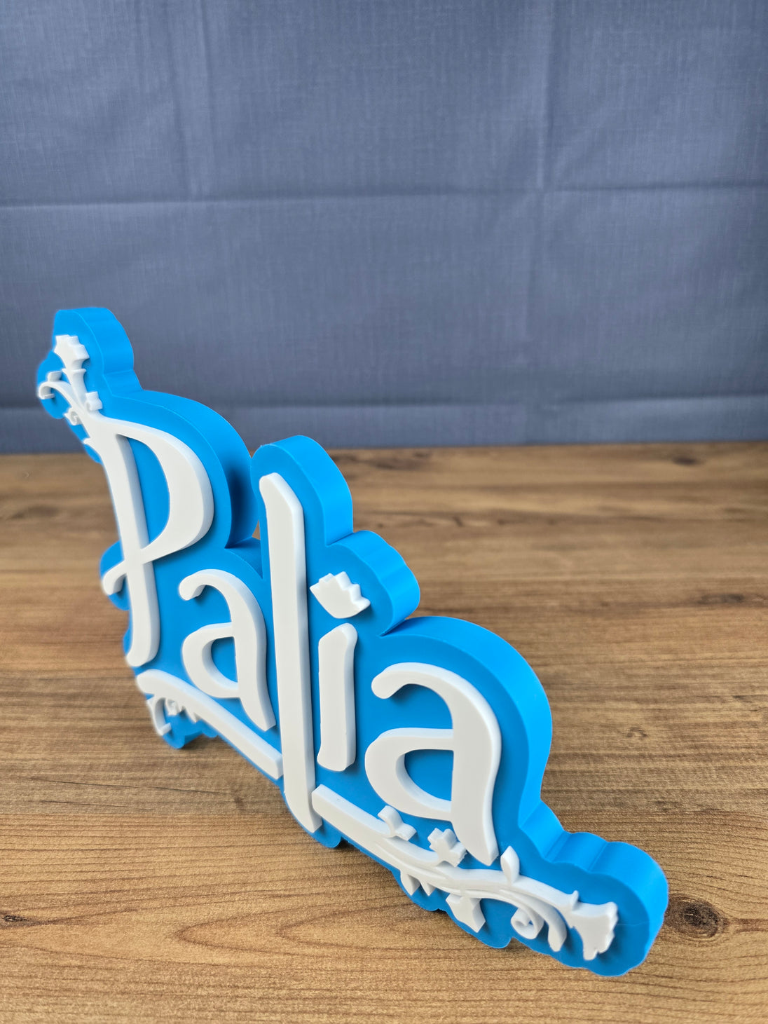 Palia logo display stand angled side view