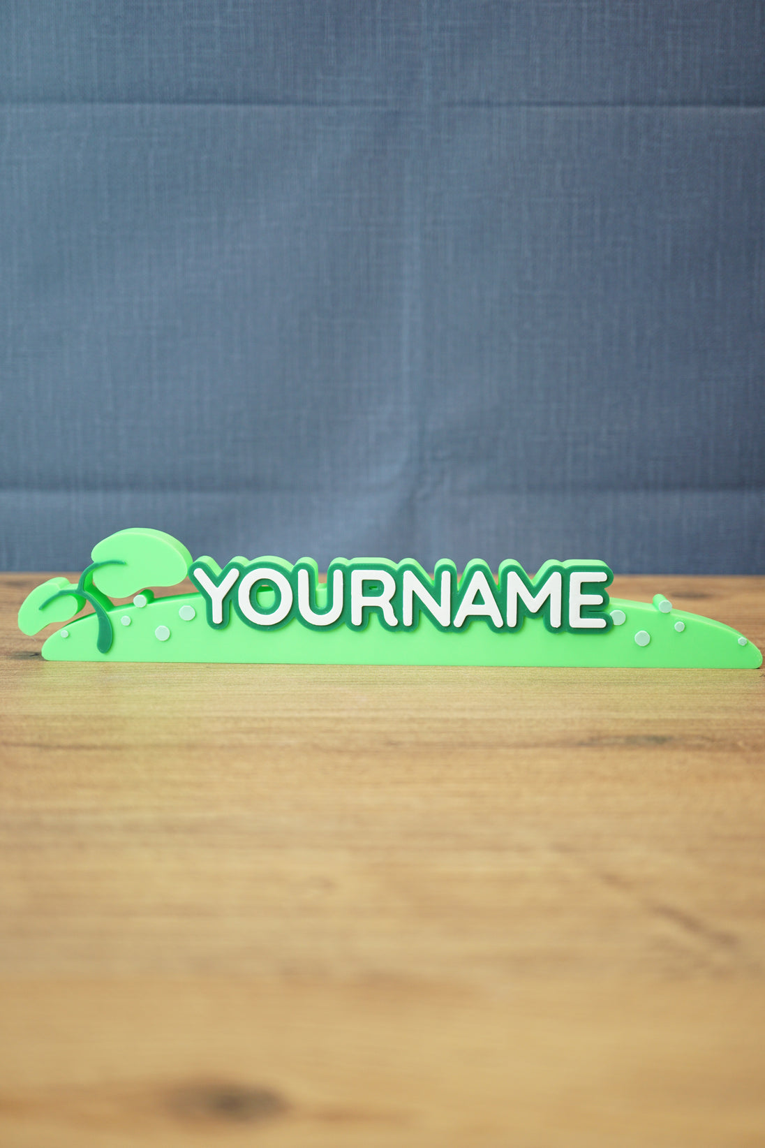 Palia New in Town nameplate sign shown from the front with green leafy details, raised white lettering, and a slim 25cm display shape.