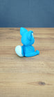 Back side view of a bright blue 3D printed One-in-Ten-Million Palcat plush figure showing its white-tipped curled tail, large ears, and seated body shape.