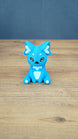 Front view of a bright blue 3D printed One-in-Ten-Million Palcat plush figure with white chest, ear details, paw pads, black eyes, and tiny white fangs.