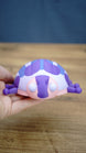 Palia Princess Ladybug collectible held in a hand to demonstrate its compact size, with pink, purple, blue and white character details visible