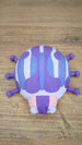 Top view of the Palia Princess Ladybug collectible showing symmetrical purple and blue shell markings, pink body and six purple ladybug legs