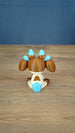 Rear view of the Proudhorned Sernuk-inspired plush figure showing cream, brown, and blue tail coloring.