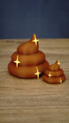 Large and small QualityUp Palia fertilizer collectibles featuring warm brown colouring and bright gold sparkling star decorations.