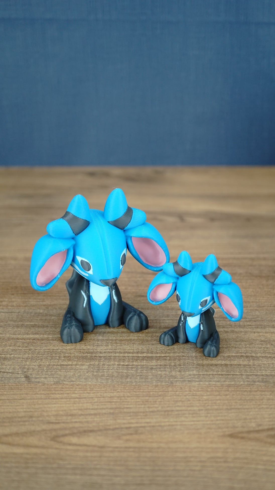 Two Royal Sernuk plush figures from Palia displayed together, showing the large and small 3D printed collectible versions.