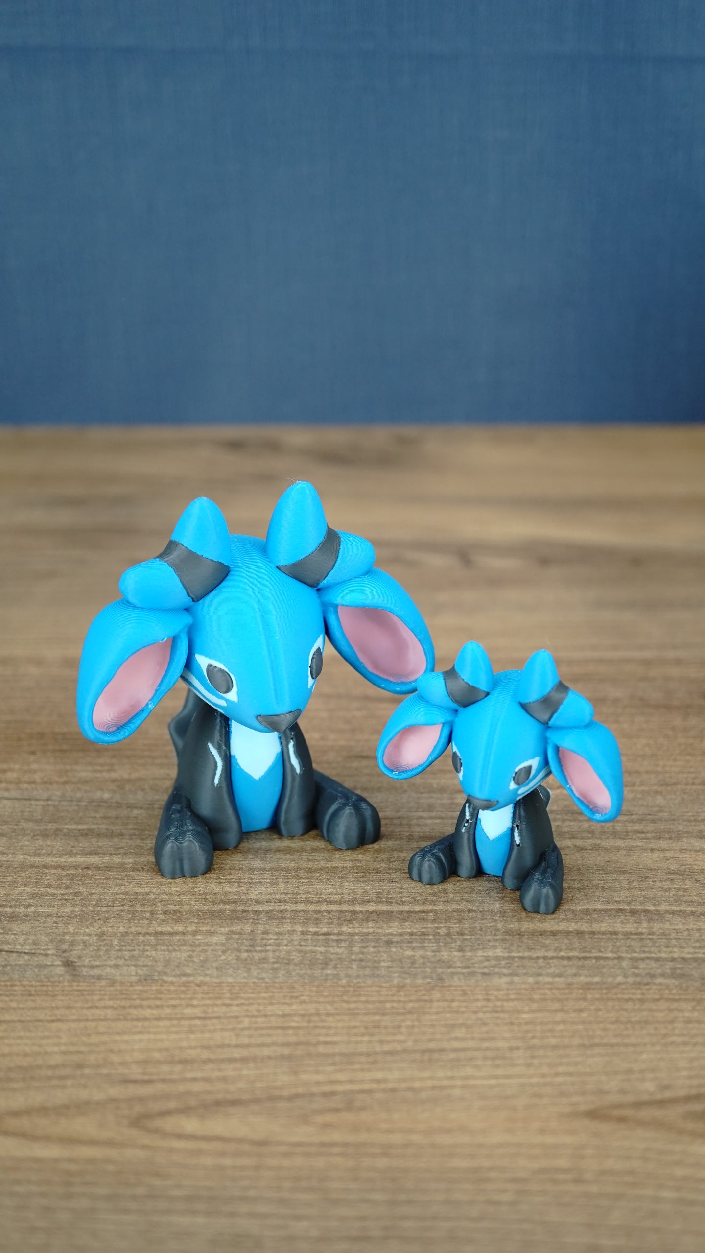 Two Royal Sernuk plush figures from Palia displayed together, showing the large and small 3D printed collectible versions.