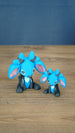 Two Royal Sernuk plush figures from Palia displayed together, showing the large and small 3D printed collectible versions.