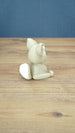 Back side view of a 3D printed Sandi the Palcat plush figure showing its curled tail with white tip, seated pose, and large ears.