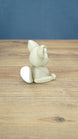 Back side view of a 3D printed Sandi the Palcat plush figure showing its curled tail with white tip, seated pose, and large ears.