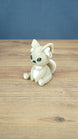 Side view of a 3D printed Sandi the Palcat plush figure showing its curled tail, large pointed ears, white accents, and green eyes.