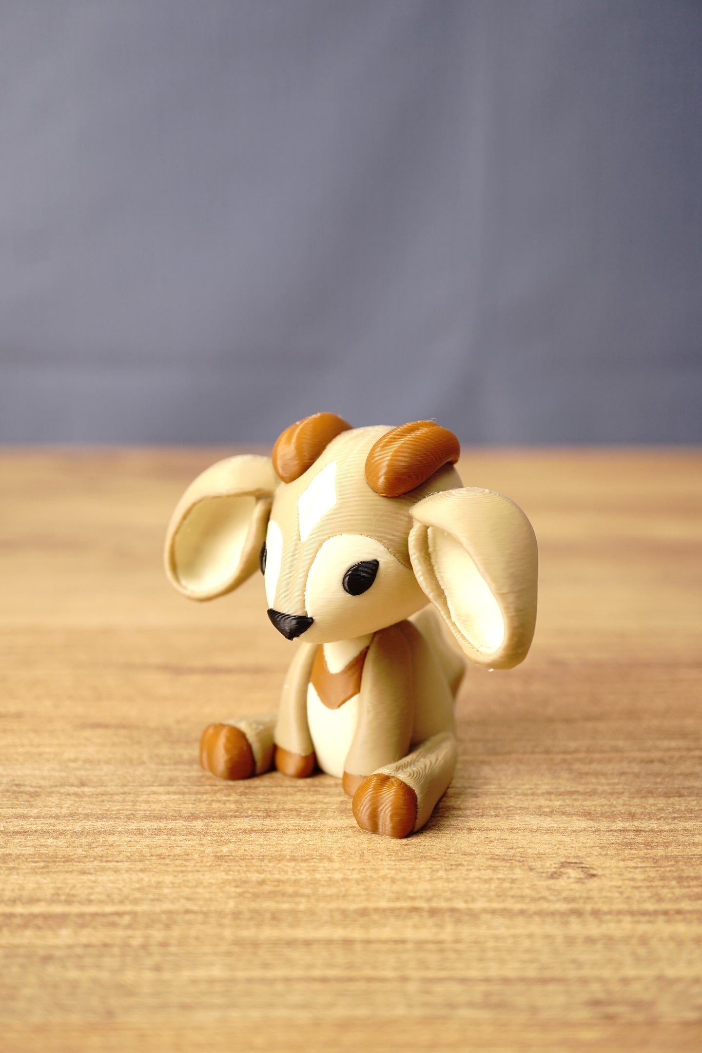 Angled view of a Palia-inspired Sernuk collectible by Created by Lou showing its oversized ears, seated pose and detailed face.