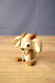Angled view of a Palia-inspired Sernuk collectible by Created by Lou showing its oversized ears, seated pose and detailed face.