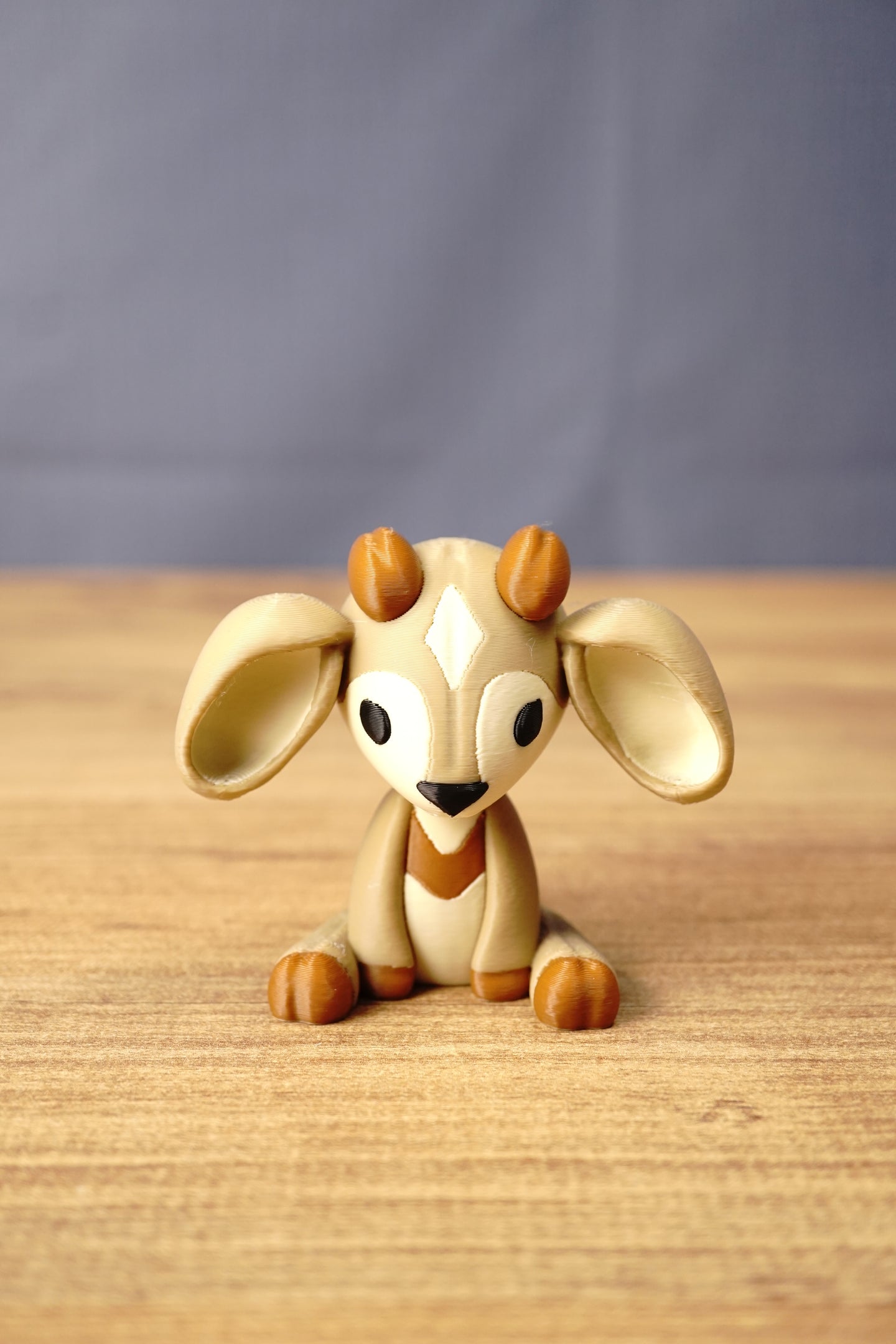 Front view of a Palia Sernuk Plush figure by Created by Lou with large cream ears, brown horns and a diamond forehead marking.