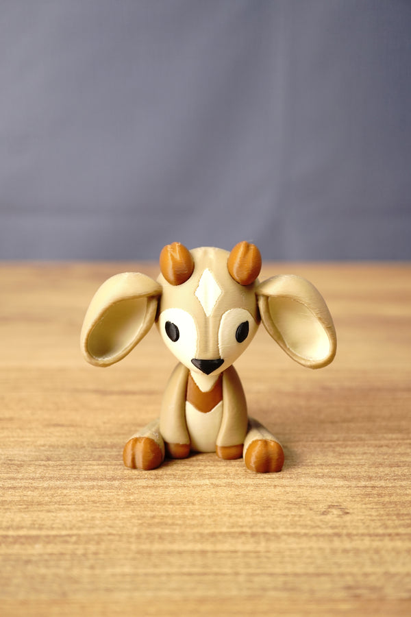 Front view of a Palia Sernuk Plush figure by Created by Lou with large cream ears, brown horns and a diamond forehead marking.