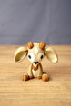 Front view of a Palia Sernuk Plush figure by Created by Lou with large cream ears, brown horns and a diamond forehead marking.