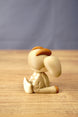 Rear side view of a Sernuk Plush figure by Created by Lou showing its curved tail, large ear and decorative white back spots.