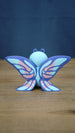 Rear view of the Palia Shimmerfly collectible figure highlighting the large symmetrical purple wings with light blue and soft pink patterned details