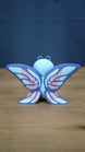 Rear view of the Palia Shimmerfly collectible figure highlighting the large symmetrical purple wings with light blue and soft pink patterned details