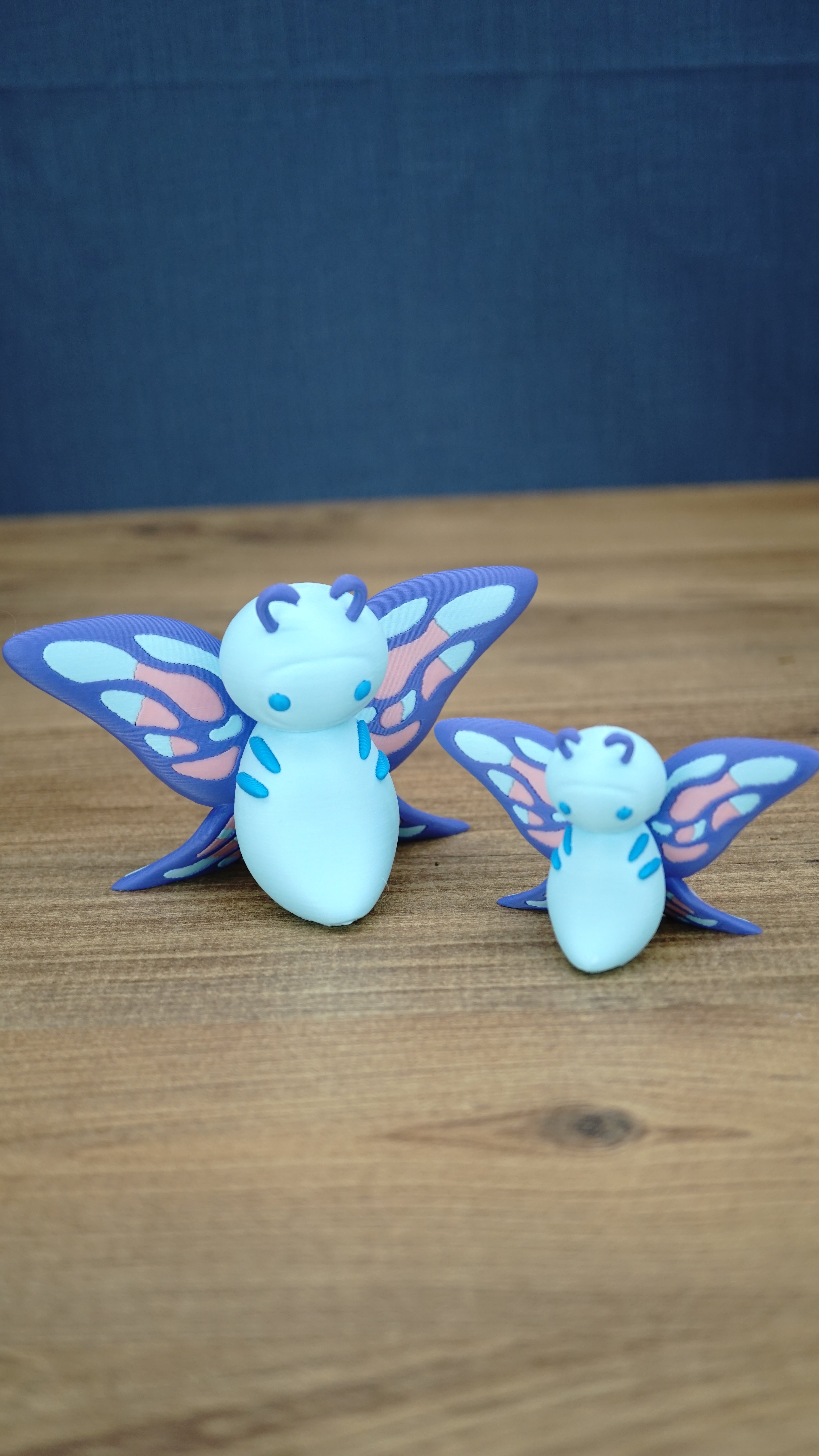 Palia Shimmerfly Plush inspired collectible figures in 12cm and 8cm sizes, featuring light blue bodies with pink, blue and purple butterfly wings