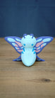 Front view of a Palia Shimmerfly Plush inspired figure with a light blue body, curled purple antennae and large decorative pink and blue wings