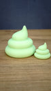 Large and small SpeedyGro Palia fertilizer collectibles in a distinctive pale green finish, displayed side by side on a wooden surface.
