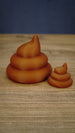 Large and small WeedBlock Palia fertilizer collectibles in rich green with a raised golden plant emblem on the front of each design.