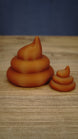 Large and small WeedBlock Palia fertilizer collectibles in rich green with a raised golden plant emblem on the front of each design.