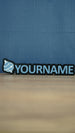 Front view of a light blue and white Palworld Sphere personalised nameplate on a black base, with bold YOURNAME lettering for desk or shelf display.