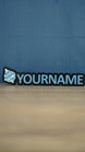 Front view of a light blue and white Palworld Sphere personalised nameplate on a black base, with bold YOURNAME lettering for desk or shelf display.