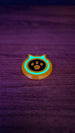 Single glow-in-the-dark Palworld-inspired dog coin replica with a turquoise glowing ring and paw-print design on a dark tabletop.