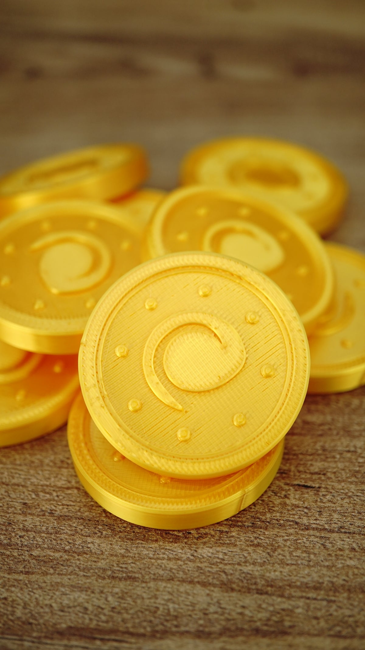 Stack of fan-made Palworld Gold Coin replicas showing the metallic-style gold silk finish, suitable for gaming displays, cosplay props or themed collections.