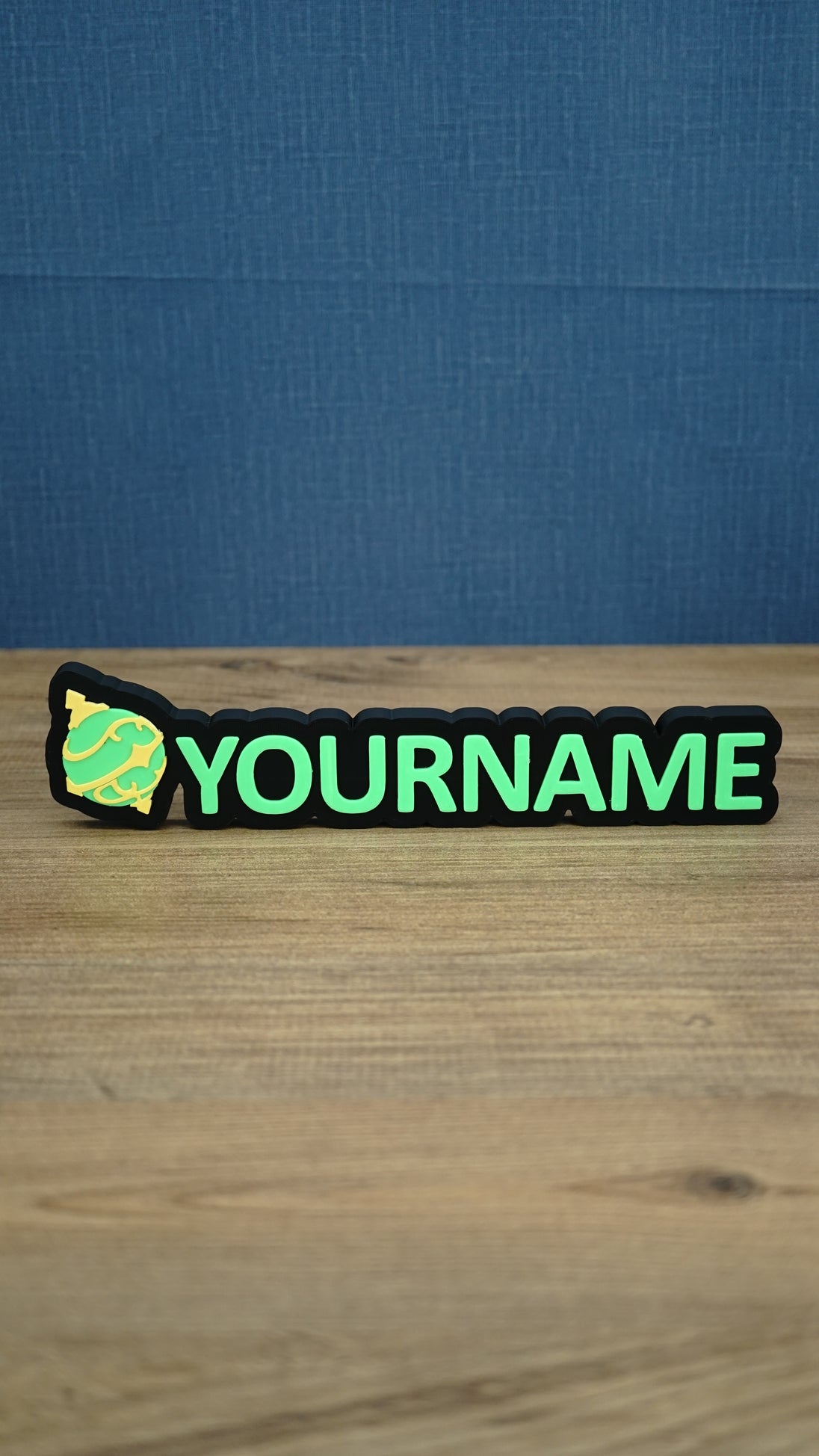 Personalised Palworld Sphere nameplate in bright green and yellow on a black base, displayed front-on as colourful gamer desk and bedroom décor.