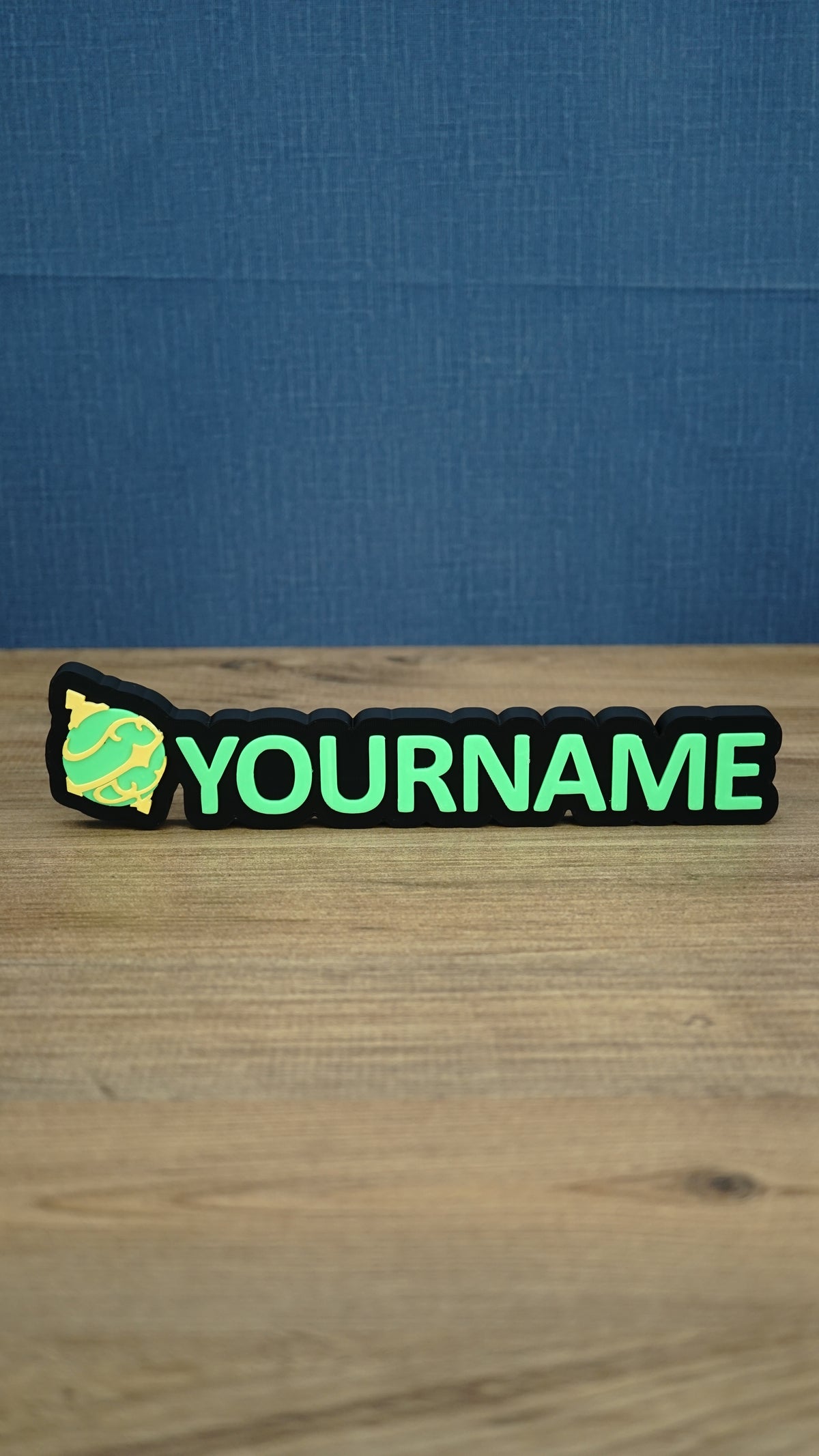 Personalised Palworld Sphere nameplate in bright green and yellow on a black base, displayed front-on as colourful gamer desk and bedroom décor.