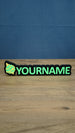 Personalised Palworld Sphere nameplate in bright green and yellow on a black base, displayed front-on as colourful gamer desk and bedroom décor.