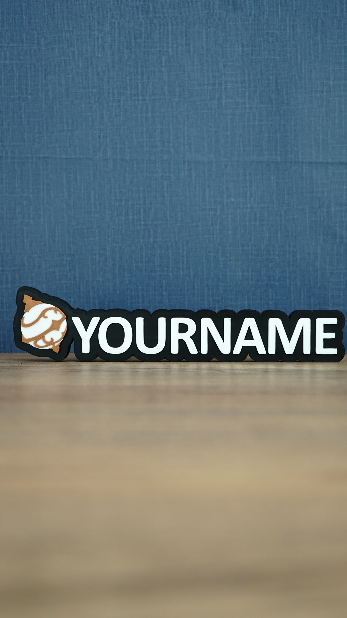 Front view of a white and bronze Palworld Sphere personalised nameplate on a black base, with bold YOURNAME lettering for gaming room display.