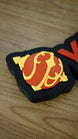 Close-up of the orange and yellow Sphere emblem on a personalised Palworld nameplate, paired with orange lettering on a black display base.