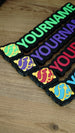 Angled group display of personalised Palworld Sphere nameplates in green, purple, red and blue, showing multiple colour options for gamer décor.