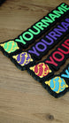 Angled group display of personalised Palworld Sphere nameplates in green, purple, red and blue, showing multiple colour options for gamer décor.