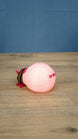 Rear view of the pink glow lantern bug plush showing its rounded pink body and tail details.