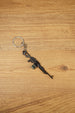 Close-up angled PKM rifle keyring with detailed LMG shape, metal chain and key ring, made for FPS fans and gaming gift collections