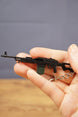 PKM metal rifle keychain held in hand with visible chain and detailed LMG body, perfect for tactical shooter fans and collector displays