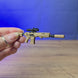 3D-printed SIG MCX Spear rifle keychain shown being held and rotated by hand, designed as a miniature rifle-inspired accessory or keyring.